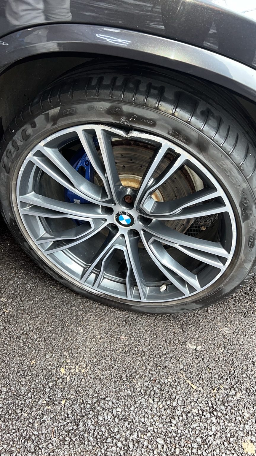 Damaged car tyre and alloy needing urgent replacement